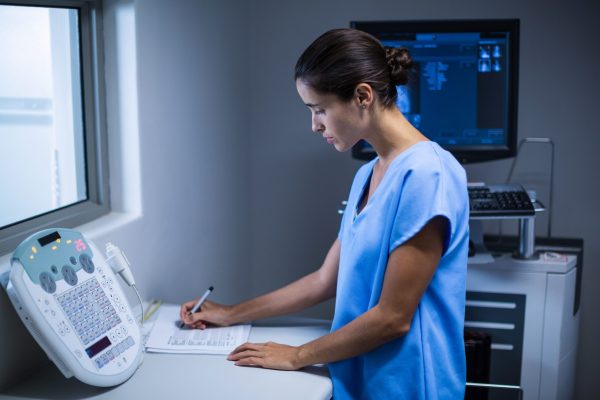 nurse-taking-notes-in-x-ray-room-min